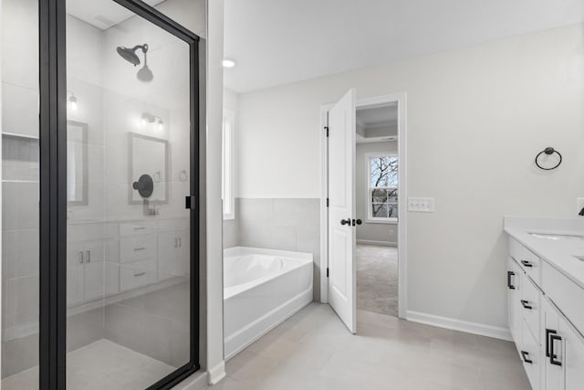 bathroom with independent shower and bath, tile patterned flooring, and vanity