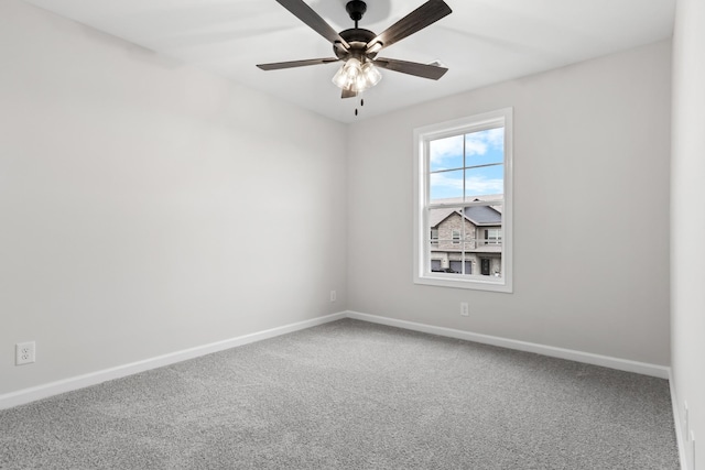 carpeted empty room featuring ceiling fan