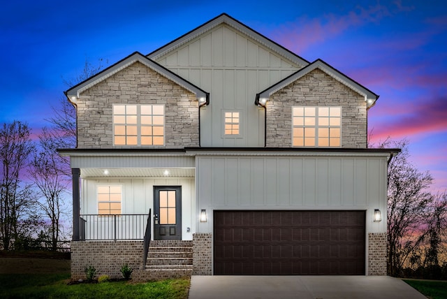 view of front of home featuring a garage and a porch