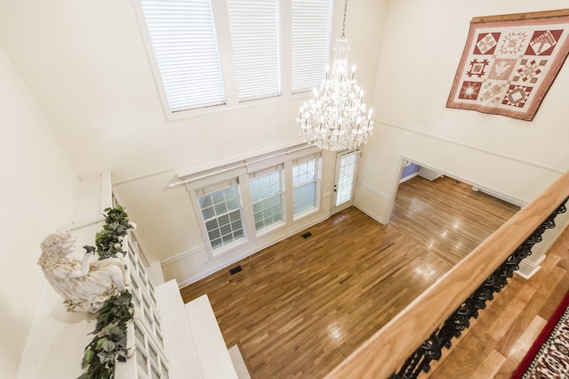 living room featuring hardwood / wood-style flooring and an inviting chandelier