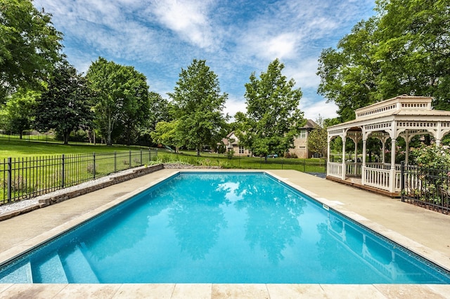 view of swimming pool featuring a lawn and a gazebo