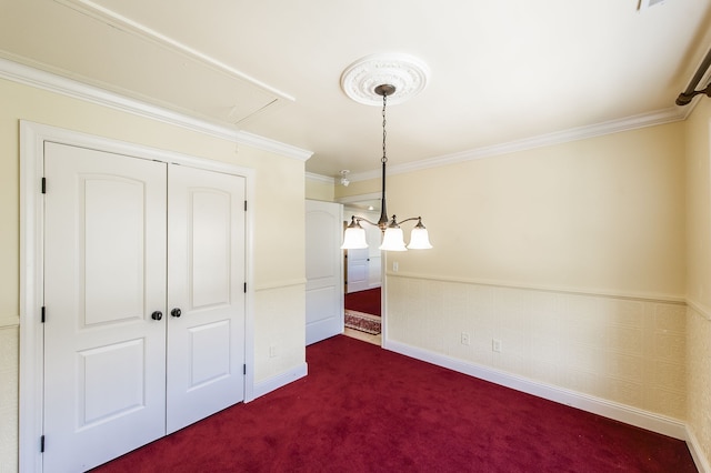 unfurnished dining area featuring crown molding and dark carpet