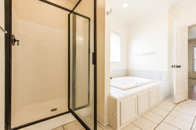 bathroom with tile patterned floors, separate shower and tub, and ornamental molding