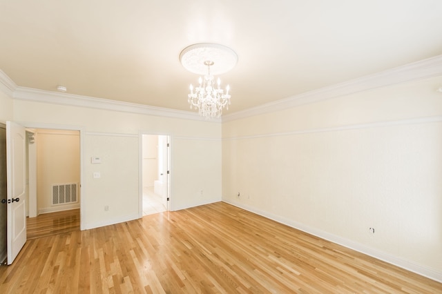 unfurnished room with a chandelier, wood-type flooring, and ornamental molding