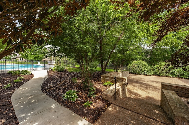 view of yard featuring a fenced in pool and a patio area