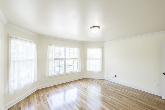 spare room with crown molding and light hardwood / wood-style flooring