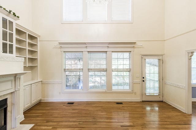 unfurnished living room featuring hardwood / wood-style flooring