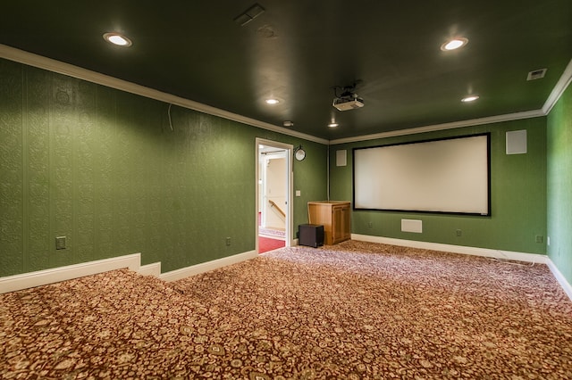 carpeted home theater room featuring crown molding