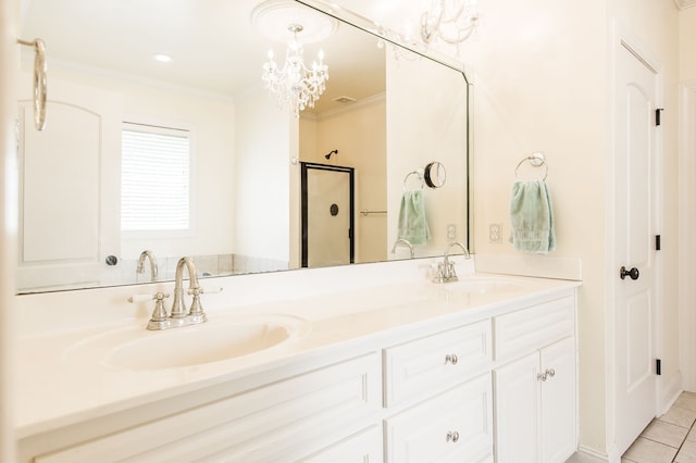 bathroom with a shower with door, tile patterned flooring, vanity, crown molding, and a notable chandelier