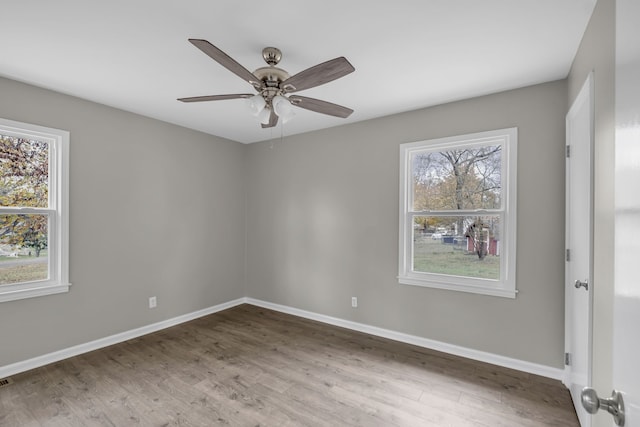 unfurnished room featuring hardwood / wood-style floors and ceiling fan