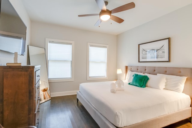 bedroom with dark hardwood / wood-style flooring and ceiling fan