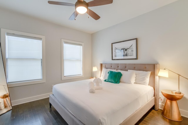 bedroom with dark hardwood / wood-style floors and ceiling fan