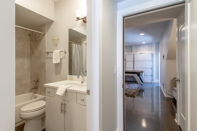 full bathroom with toilet, concrete flooring, shower / tub combo with curtain, and vanity