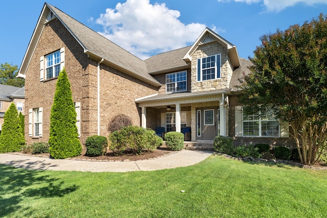 view of front of house featuring covered porch and a front lawn