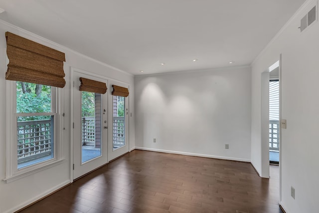 unfurnished room with dark wood-type flooring, french doors, and ornamental molding