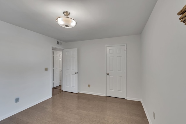 spare room featuring hardwood / wood-style floors