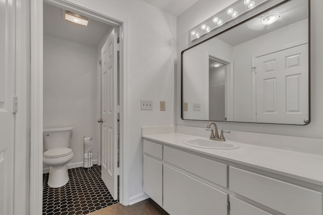 bathroom featuring tile patterned flooring, vanity, and toilet