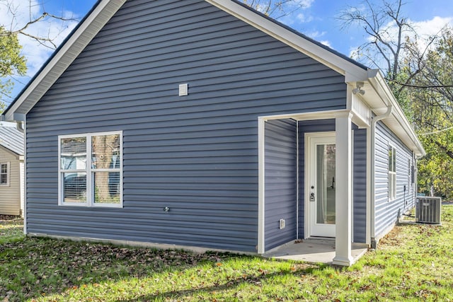 rear view of property featuring central AC unit