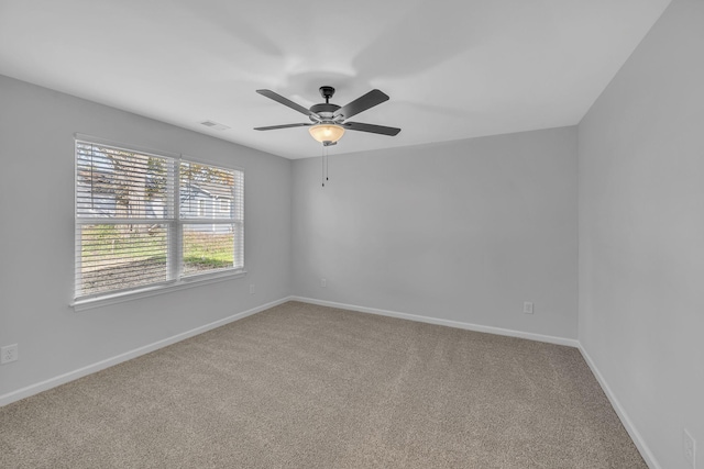 carpeted spare room with ceiling fan