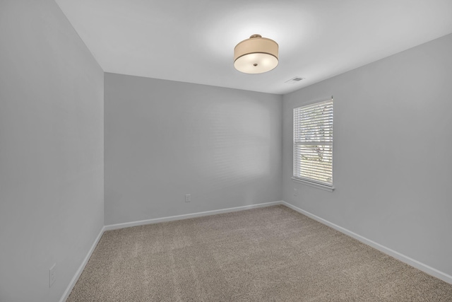 unfurnished room featuring carpet