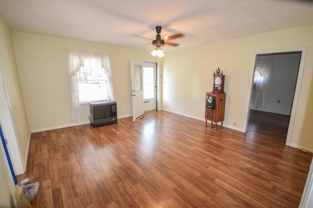 spare room with dark hardwood / wood-style flooring and ceiling fan