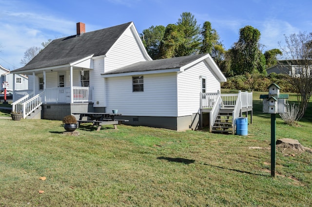 rear view of house with a yard