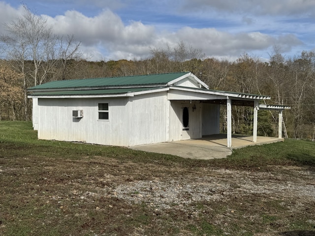 view of outdoor structure with an AC wall unit