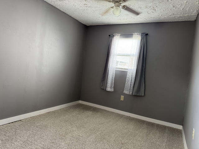 empty room with ceiling fan, a textured ceiling, and carpet flooring