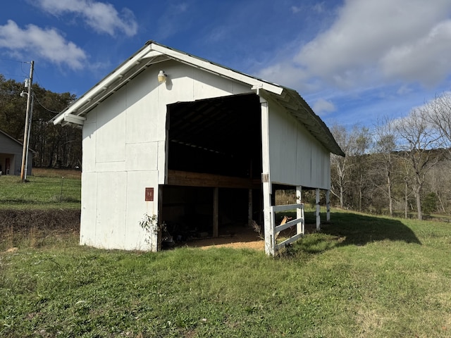 view of outbuilding featuring a lawn