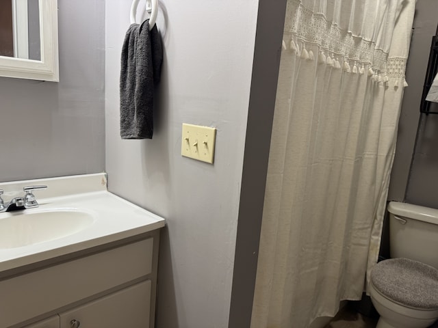 bathroom featuring vanity and toilet