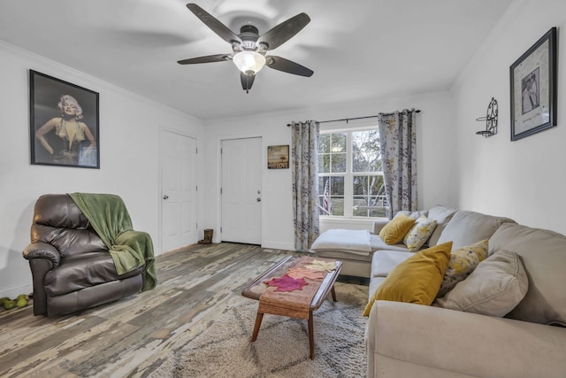 living room featuring ornamental molding, hardwood / wood-style flooring, and ceiling fan