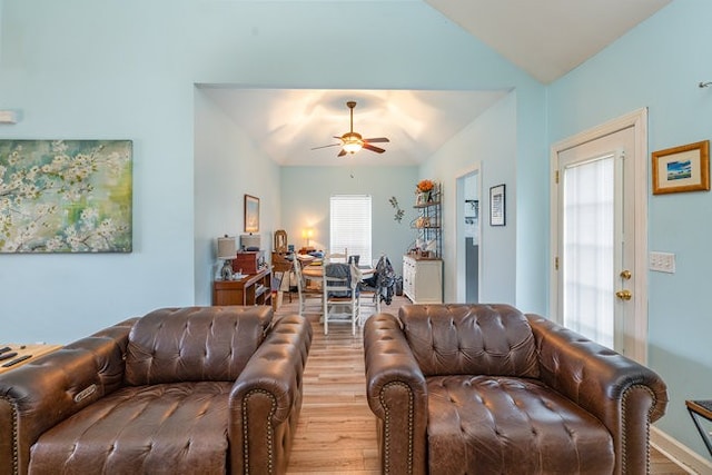 living room featuring lofted ceiling, hardwood / wood-style flooring, ceiling fan, and plenty of natural light