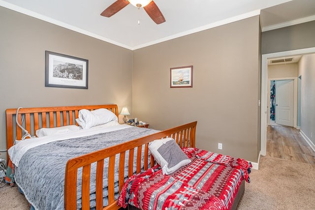 bedroom featuring light colored carpet, ceiling fan, and crown molding