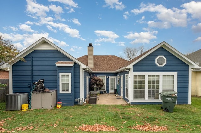 back of property with a patio, central AC, and a yard