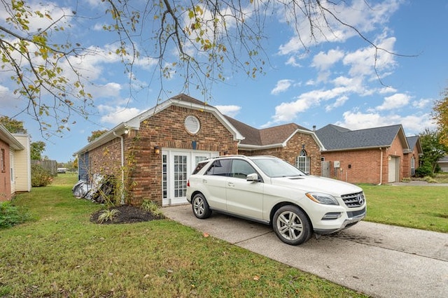 view of front of home featuring a garage and a front lawn