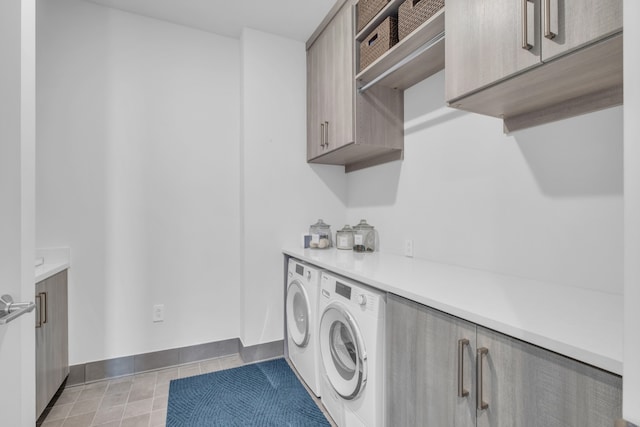 laundry area featuring independent washer and dryer and cabinets