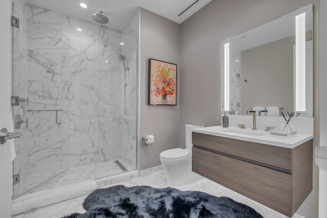 bathroom with vanity, an enclosed shower, and toilet