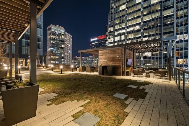 wooden terrace featuring a lawn