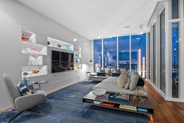 living room featuring hardwood / wood-style flooring and a wall of windows