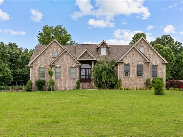 craftsman-style house featuring a front lawn and french doors