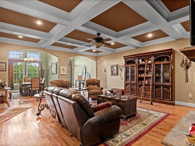 living room featuring crown molding, coffered ceiling, hardwood / wood-style floors, beamed ceiling, and ceiling fan with notable chandelier