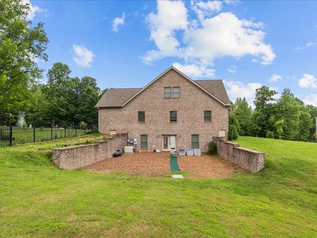 rear view of property with a lawn