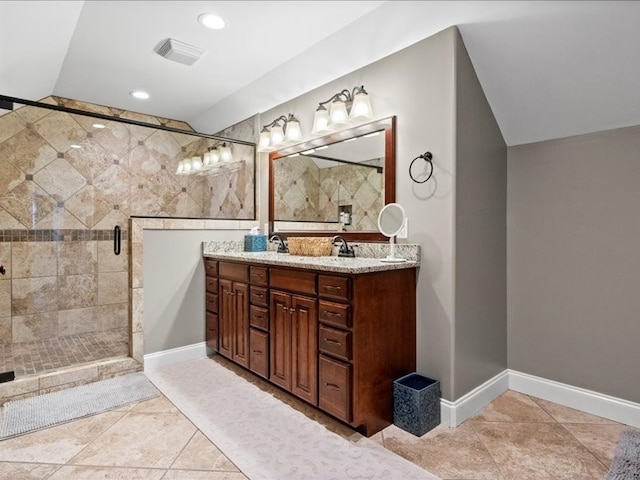 bathroom featuring walk in shower, vanity, and tile patterned floors