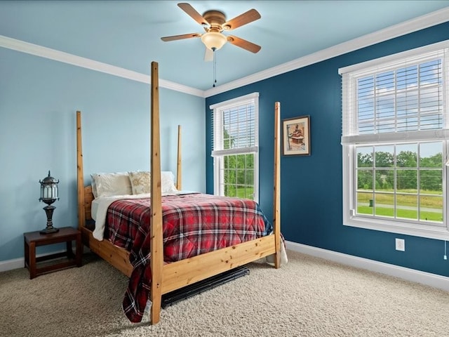 carpeted bedroom with ornamental molding, multiple windows, and ceiling fan