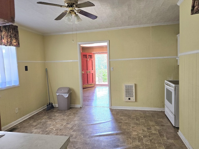 kitchen with ornamental molding, heating unit, wood walls, and white range with electric cooktop