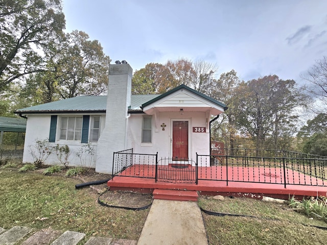 view of front of home featuring a front yard and a deck