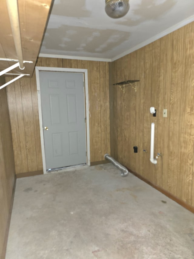 interior space featuring ornamental molding and wooden walls