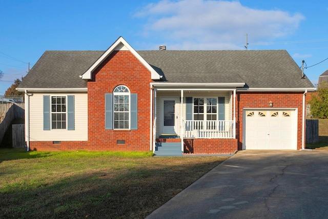 ranch-style house featuring covered porch, a front yard, and a garage