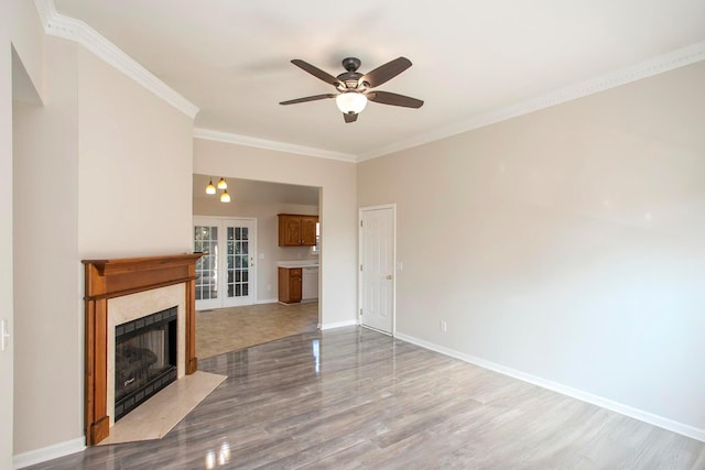 unfurnished living room featuring crown molding, french doors, ceiling fan, and wood-type flooring