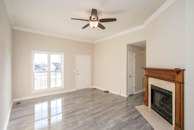 unfurnished living room with hardwood / wood-style flooring, ceiling fan, and ornamental molding